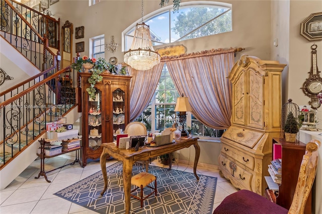 living area with light tile patterned floors, an inviting chandelier, and plenty of natural light