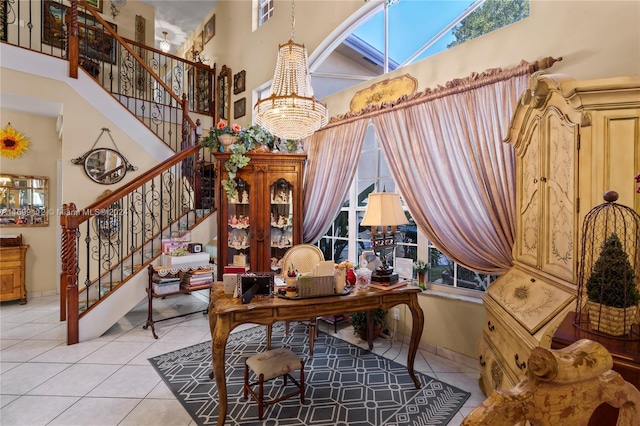 interior space with a chandelier, a high ceiling, and light tile patterned floors