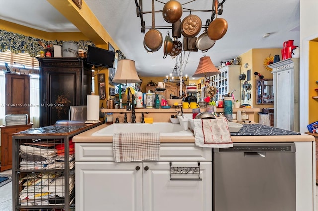 kitchen with dishwasher, white cabinets, and sink