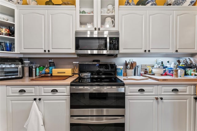 kitchen featuring white cabinetry and appliances with stainless steel finishes