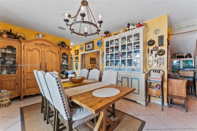 tiled dining area with a notable chandelier