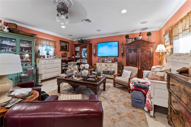 living room featuring crown molding, light tile patterned floors, and ceiling fan