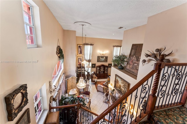 staircase featuring a textured ceiling