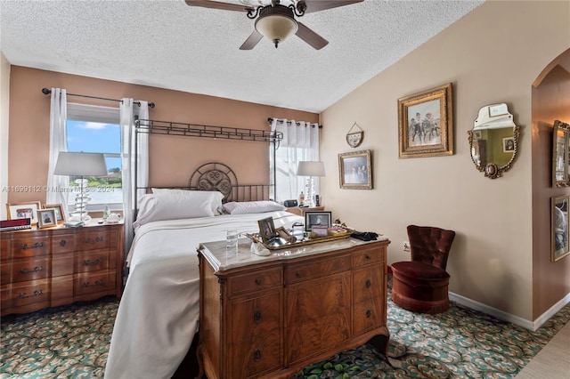 carpeted bedroom with ceiling fan, lofted ceiling, and a textured ceiling