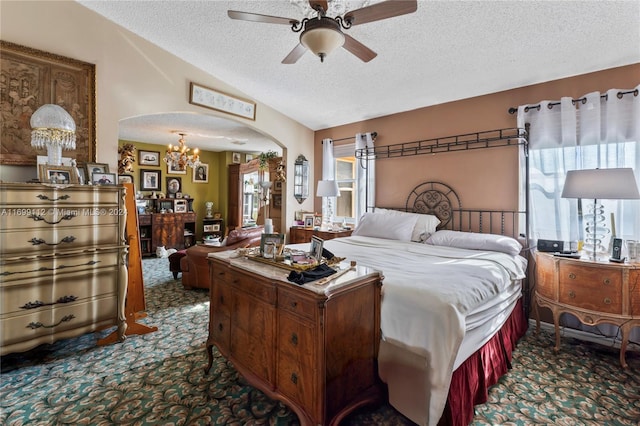 bedroom with carpet, a textured ceiling, and ceiling fan with notable chandelier