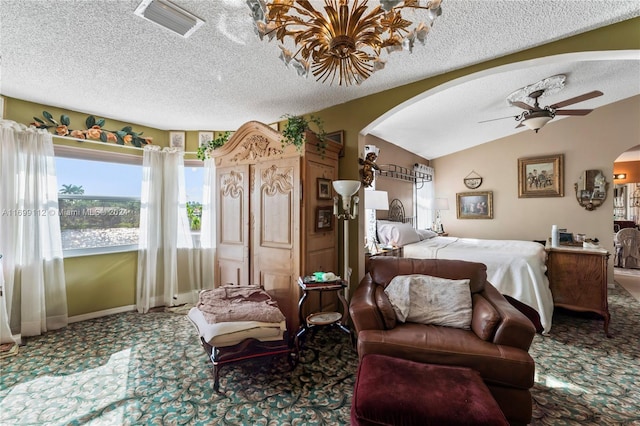 carpeted bedroom with a textured ceiling, ceiling fan, and vaulted ceiling