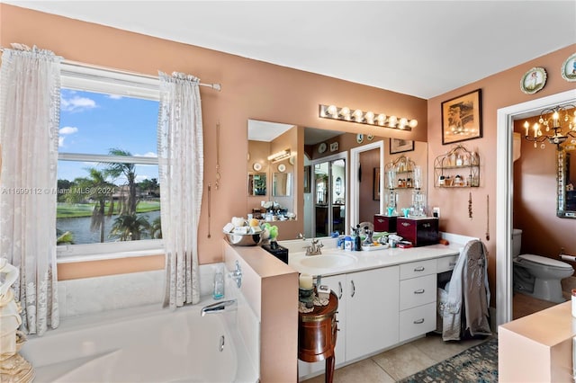 bathroom with vanity, a water view, tile patterned flooring, toilet, and a tub to relax in