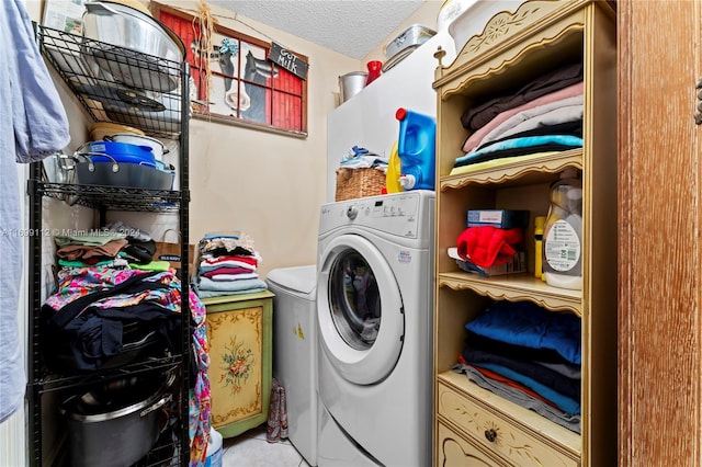 laundry area featuring washer / dryer and a textured ceiling