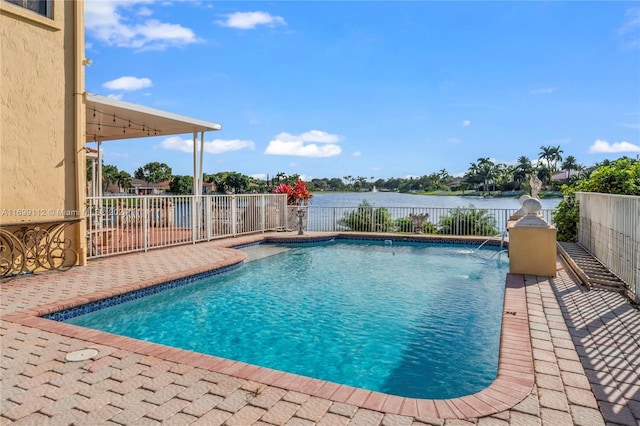 view of pool with a patio and a water view