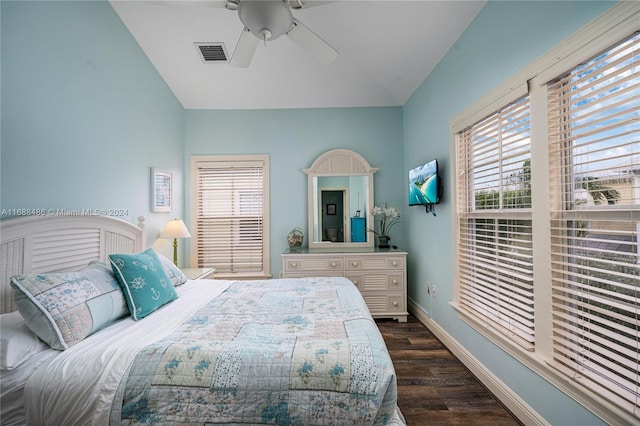 bedroom featuring dark hardwood / wood-style flooring, vaulted ceiling, and ceiling fan