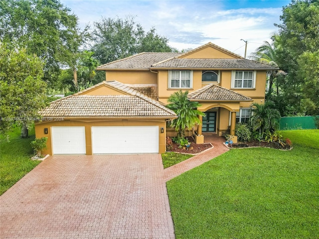 mediterranean / spanish-style home with a front yard and a garage