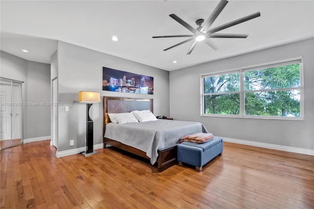 bedroom with light hardwood / wood-style floors and ceiling fan