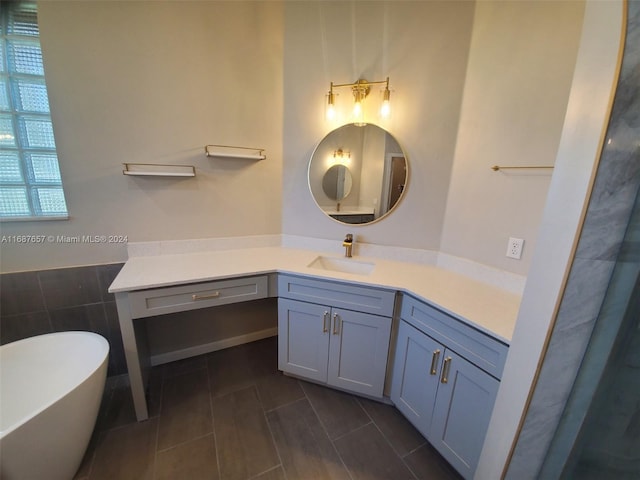 bathroom with a washtub and vanity