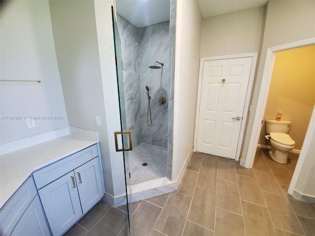 bathroom with vanity, toilet, and walk in shower