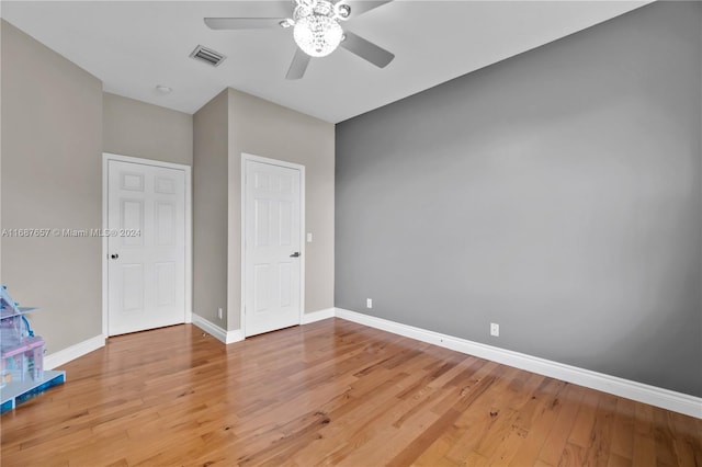 unfurnished bedroom featuring ceiling fan and hardwood / wood-style flooring