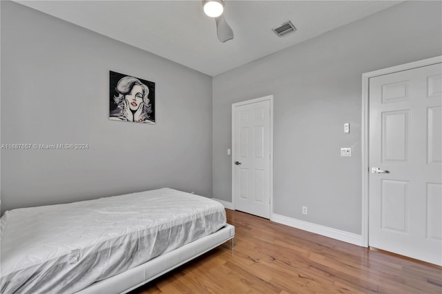 bedroom with ceiling fan and light wood-type flooring