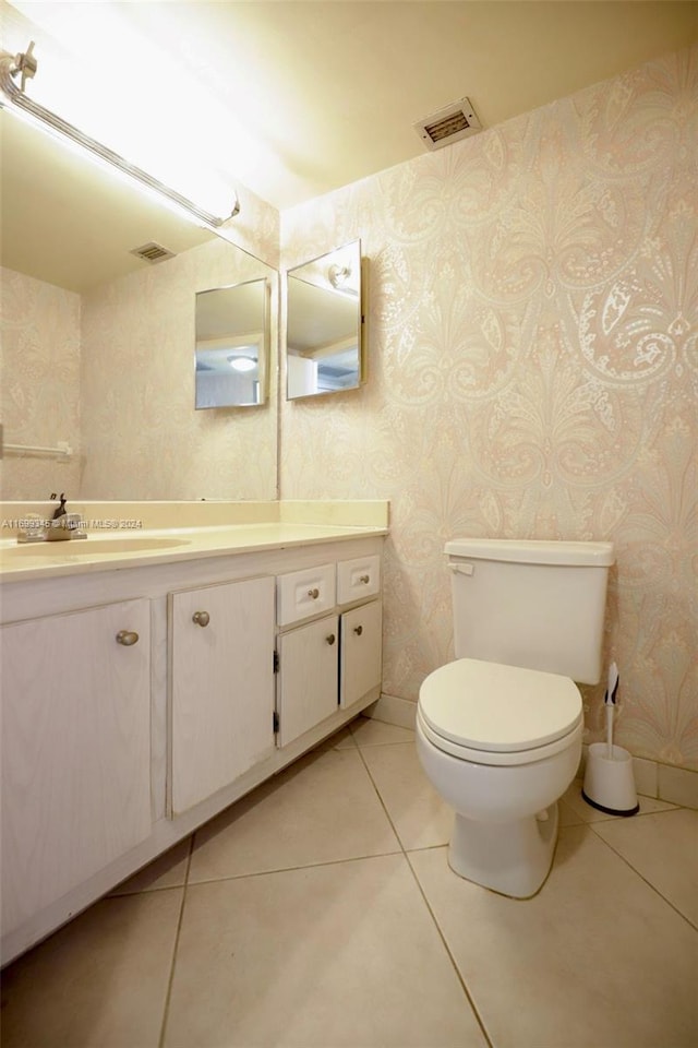 bathroom featuring tile patterned floors, vanity, and toilet