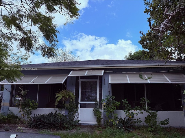 view of front of home featuring a sunroom