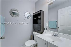 bathroom featuring vanity and toilet