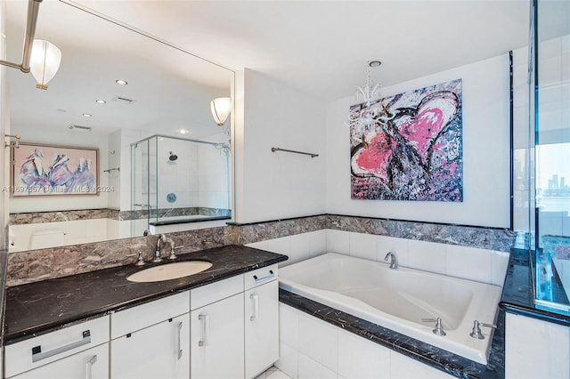 bathroom featuring vanity and separate shower and tub