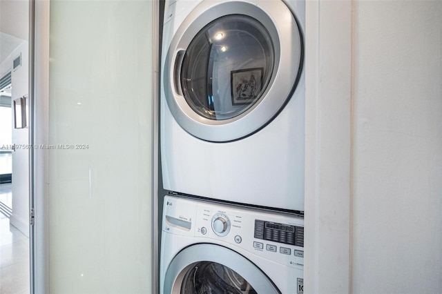 washroom with stacked washing maching and dryer