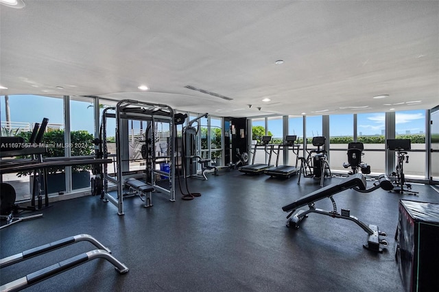 exercise room featuring a textured ceiling and floor to ceiling windows