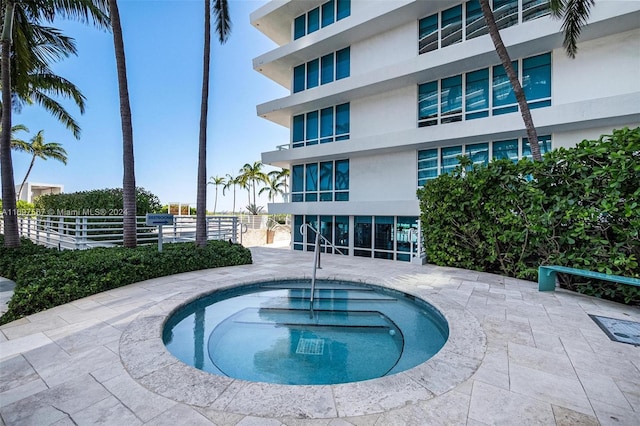 view of swimming pool with a community hot tub