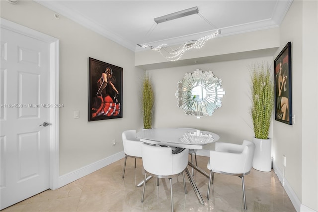 dining area featuring ornamental molding and an inviting chandelier