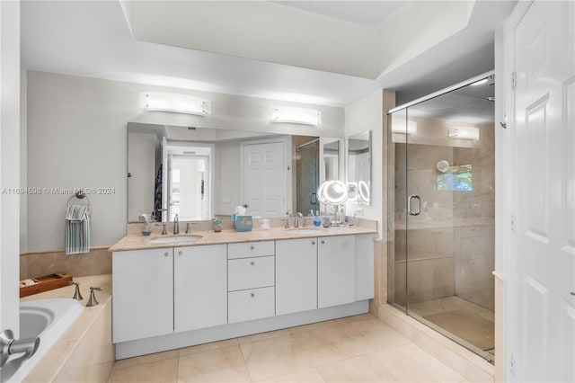 bathroom featuring tile patterned floors, vanity, and plus walk in shower