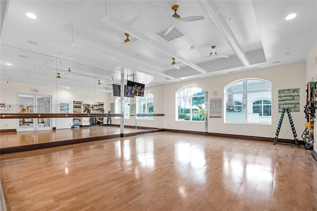 workout room with light hardwood / wood-style flooring and ceiling fan