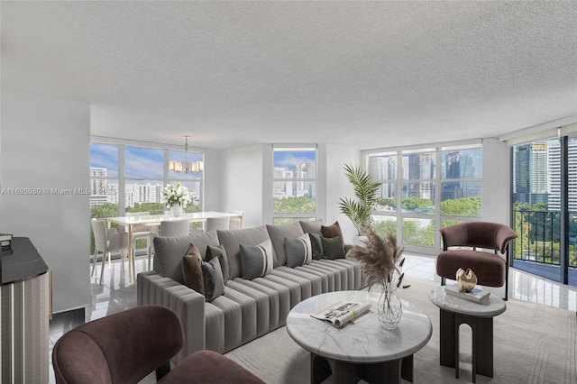 living room featuring a textured ceiling, a chandelier, and floor to ceiling windows