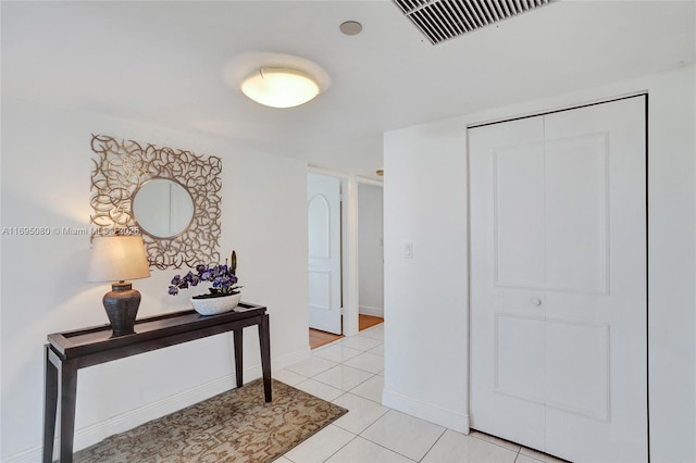 hallway featuring light tile patterned flooring