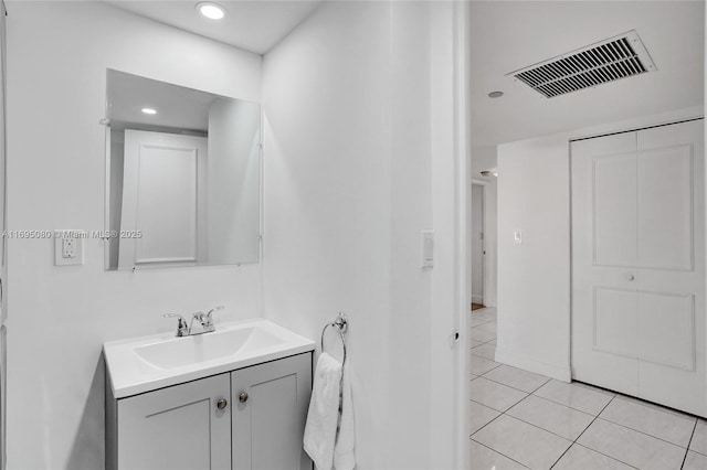 bathroom featuring tile patterned flooring and vanity