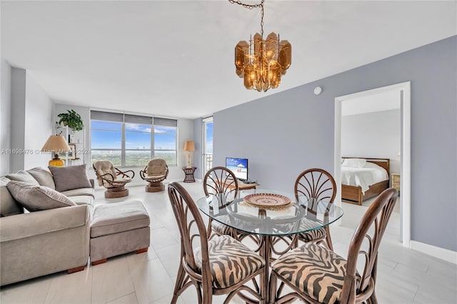 dining area featuring expansive windows, light tile patterned flooring, and a notable chandelier