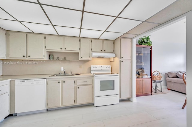 kitchen with white appliances, cream cabinets, sink, decorative backsplash, and light tile patterned floors