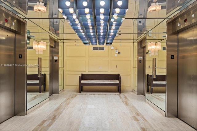 interior space with hardwood / wood-style floors and elevator