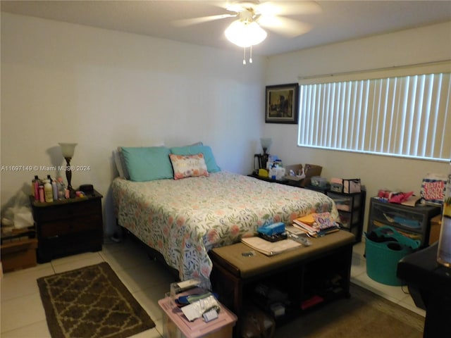 tiled bedroom featuring ceiling fan