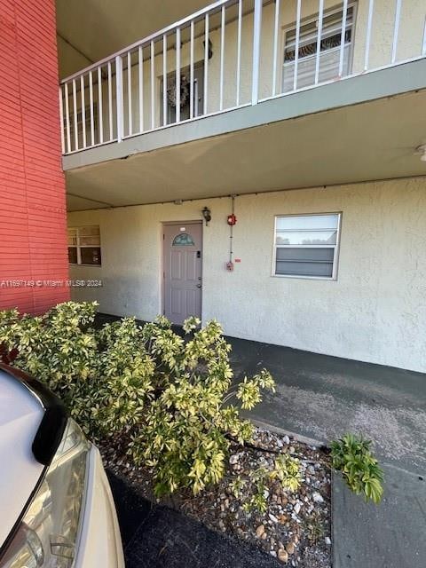 entrance to property with a balcony