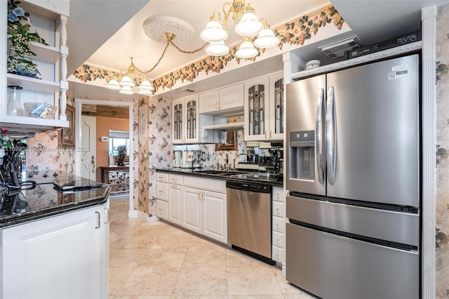 kitchen featuring an inviting chandelier, white cabinetry, and stainless steel appliances