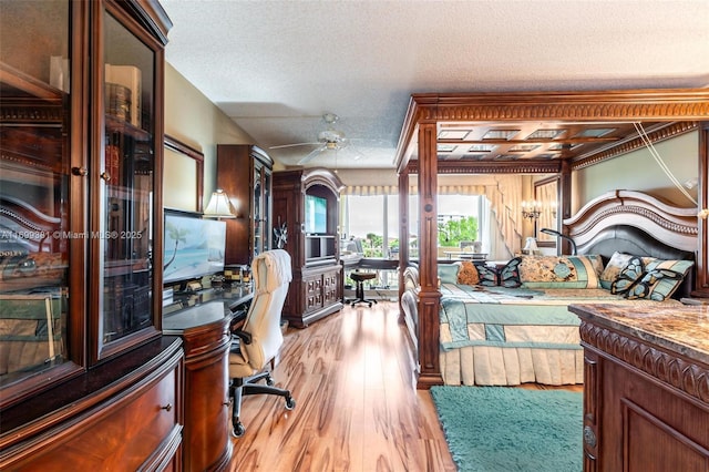 bedroom with a textured ceiling and light hardwood / wood-style flooring