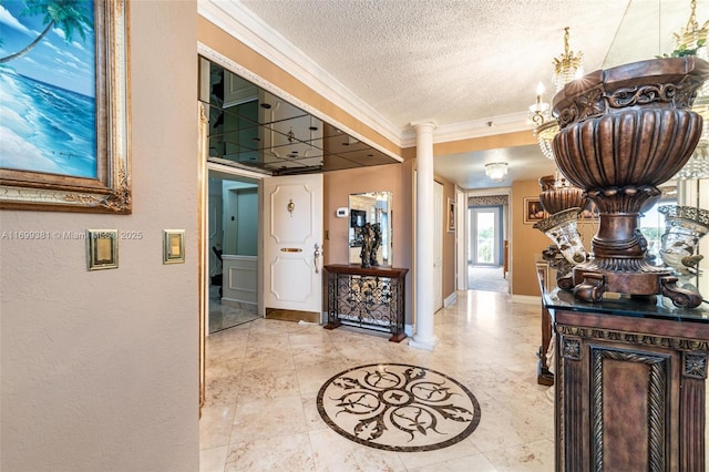 hallway featuring ornamental molding, a textured ceiling, and ornate columns