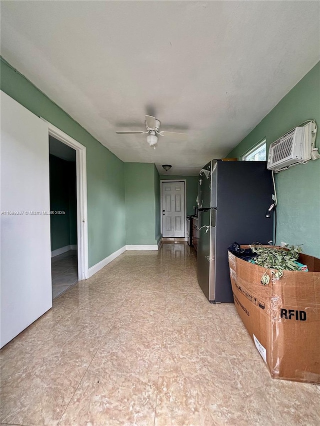 kitchen featuring ceiling fan, stainless steel fridge, and a wall mounted AC