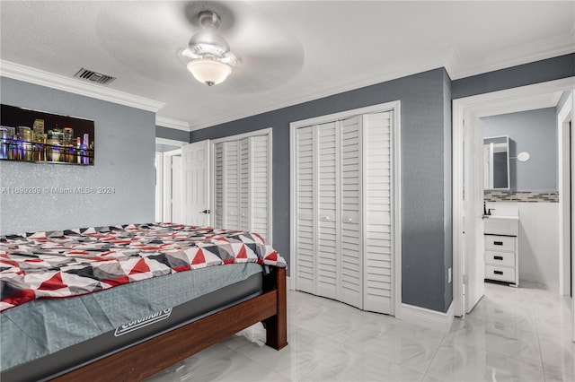 bedroom with multiple closets, ceiling fan, and ornamental molding