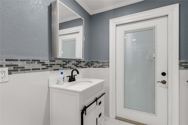 bathroom with vanity, tile walls, and ornamental molding