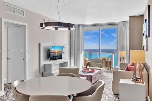 living room with a notable chandelier and floor to ceiling windows