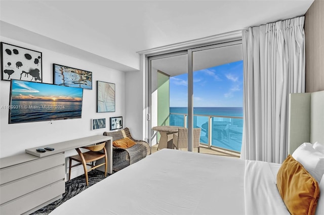 bedroom featuring access to exterior and a water view