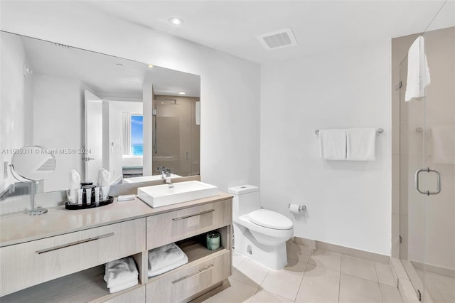 bathroom with toilet, tile patterned flooring, vanity, and walk in shower