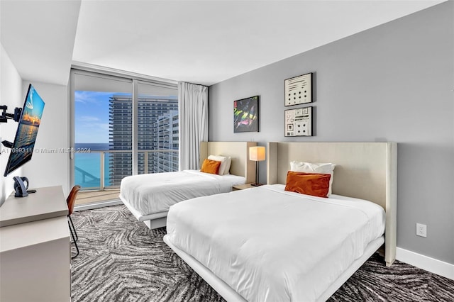 carpeted bedroom with access to outside and floor to ceiling windows