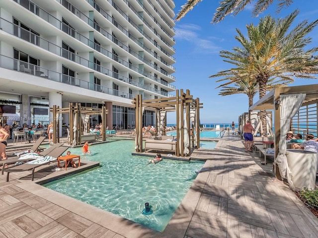 view of swimming pool with a water view