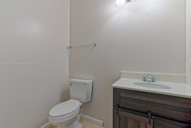 bathroom with tile patterned floors, vanity, and toilet